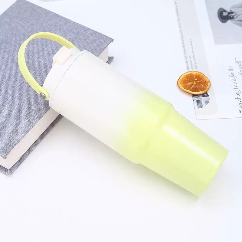 Yellow gradient insulated tumbler lying on book lifestyle shot — cute kids bottle India